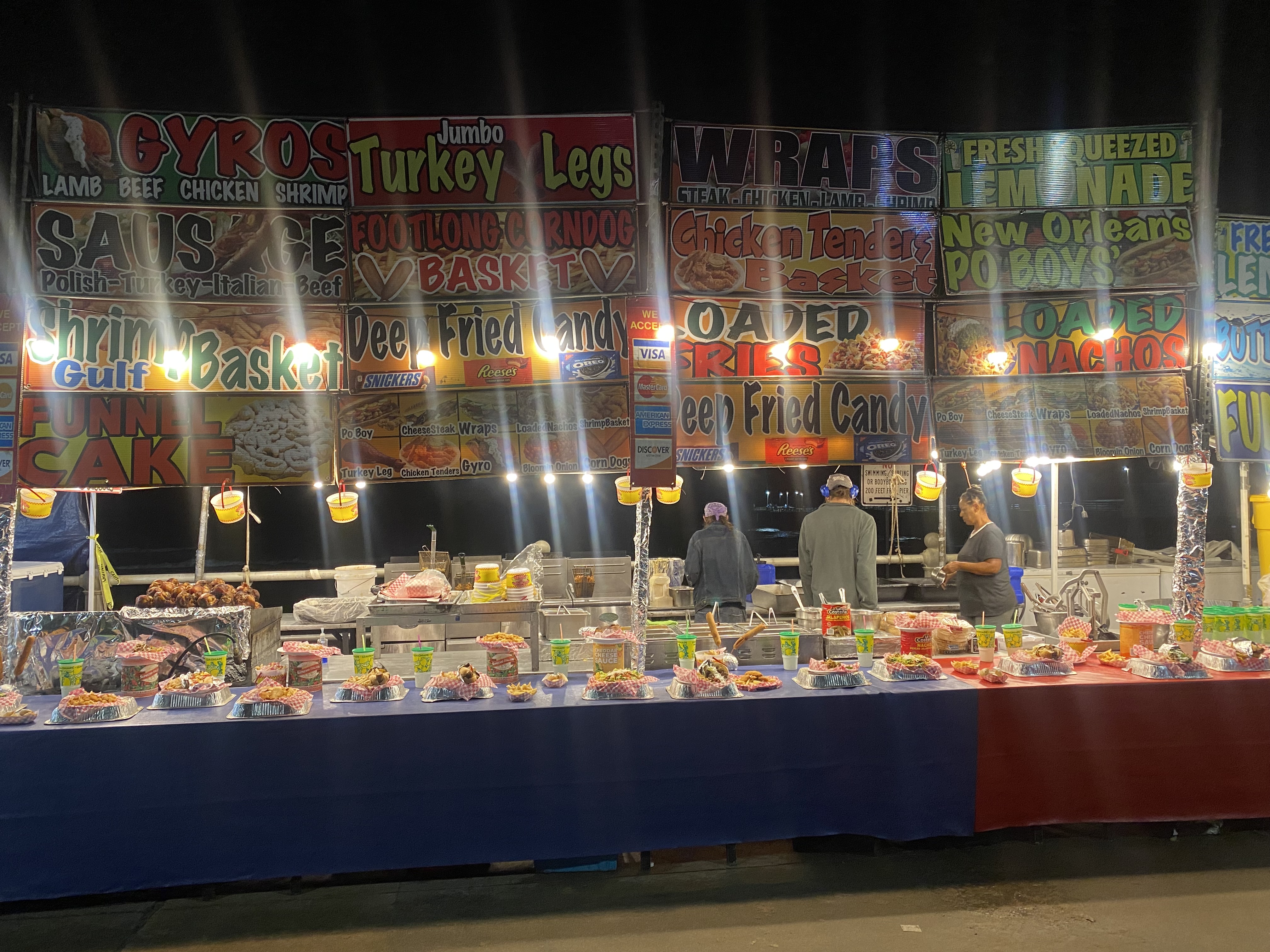 Cactus Jacks booth setup at night with full menu display